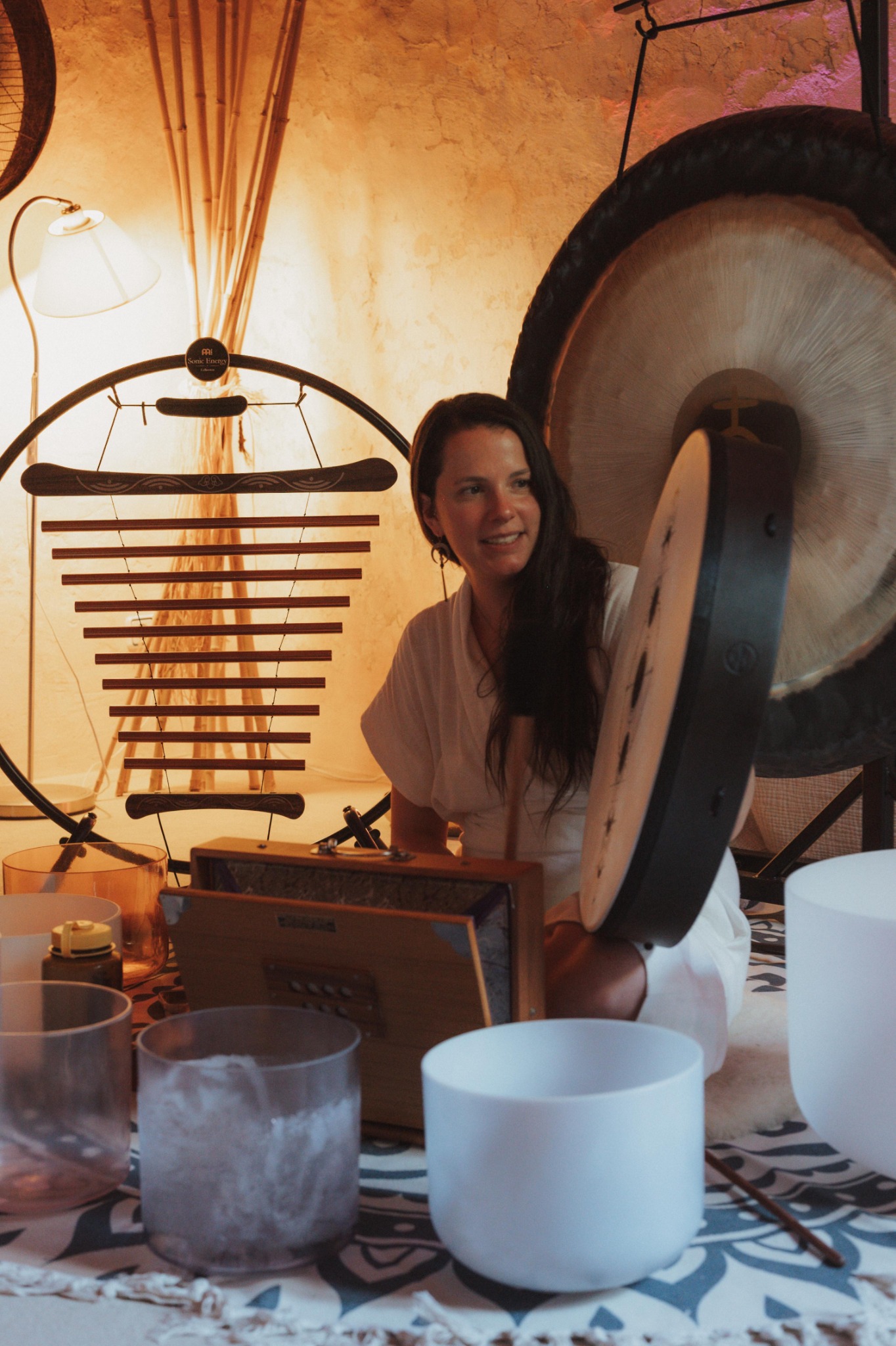 Anna with a frame drum, gong, chimes and singing bowls