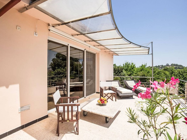 Sunlit villa terrace with views of the countryside